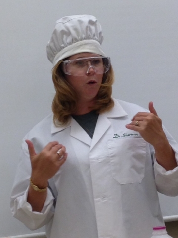 Student in a chef's hat and safety goggles.