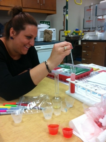 Student Teacher at a table with dna supplies.