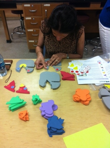 Student teacher working on crafts at a table.